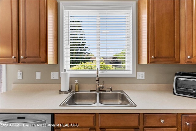 10889 Pointe W Blvd, Grand Ledge, MI 48837 - kitchen featuring stainless steel dishwasher, light countertops, and brown cabinets