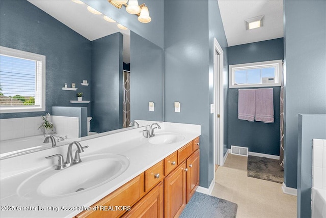 10889 Pointe W Blvd, Grand Ledge, MI 48837 - bathroom featuring double vanity and a garden tub