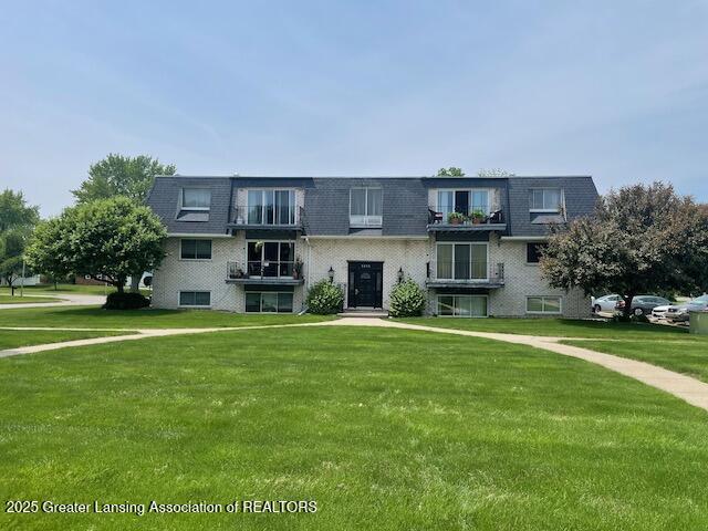 5535 W St Joe Hwy Unit B12, Lansing, MI 48917 - view of front of house featuring mansard roof, a front yard, and roof with shingles