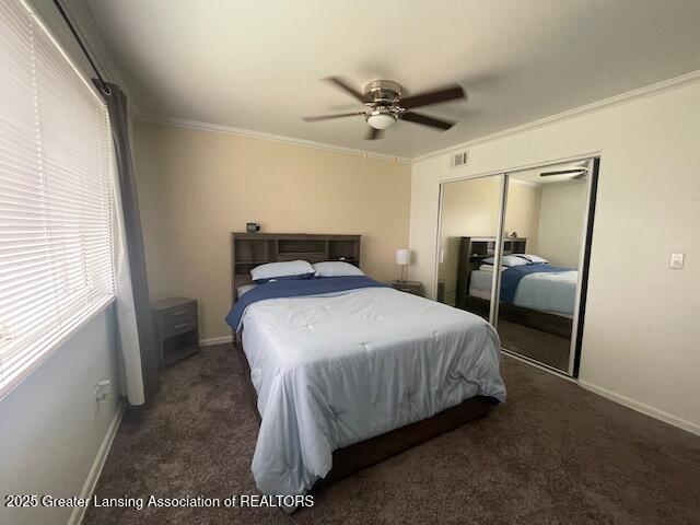5535 W St Joe Hwy Unit B12, Lansing, MI 48917 - carpeted bedroom featuring ornamental molding, a closet, and a ceiling fan