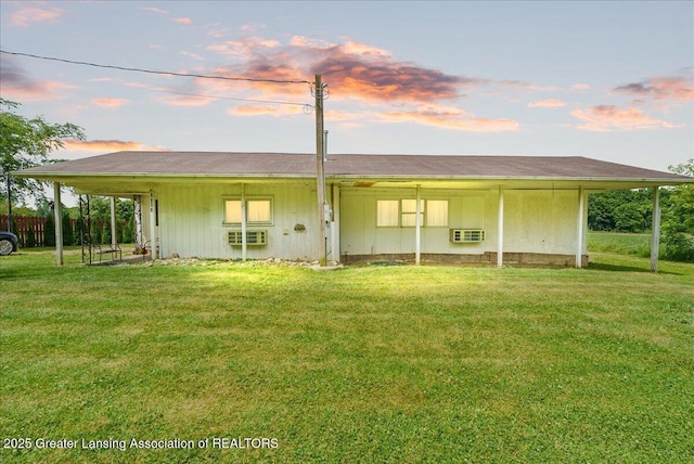 2243 Hubbard Rd, Charlotte, MI 48813 - back of property at dusk featuring a yard
