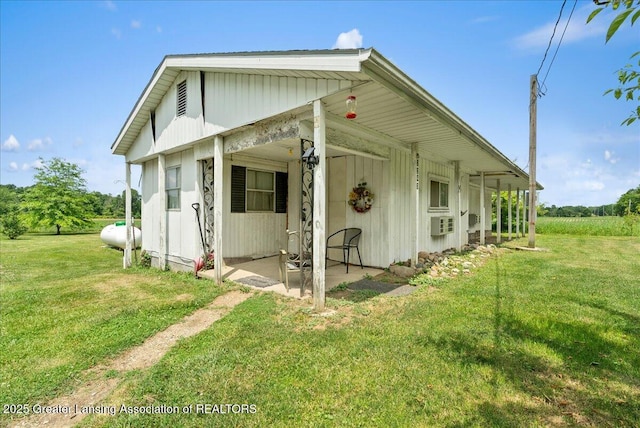 2243 Hubbard Rd, Charlotte, MI 48813 - view of property exterior with a yard and a patio