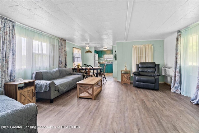 2243 Hubbard Rd, Charlotte, MI 48813 - living room with wood finished floors, a ceiling fan, and ornamental molding