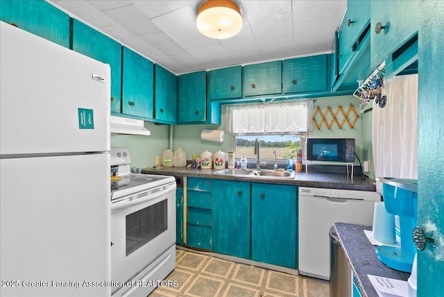 2243 Hubbard Rd, Charlotte, MI 48813 - kitchen featuring white appliances, dark countertops, under cabinet range hood, and light flooring