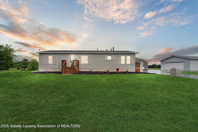 2744 Carlisle Hwy, Charlotte, MI 48813 - manufactured / mobile home featuring a front lawn and a garage