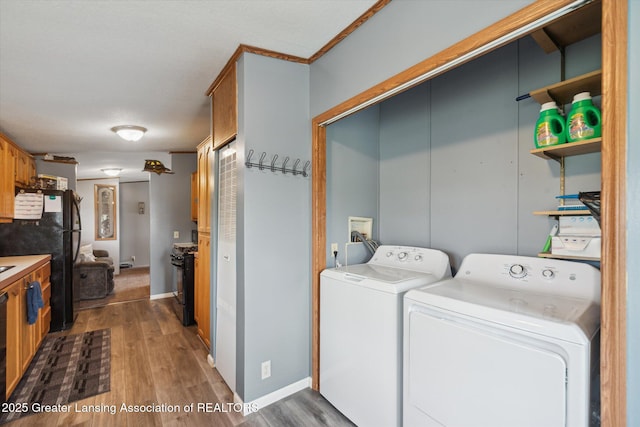 2744 Carlisle Hwy, Charlotte, MI 48813 - washroom with washer and dryer and wood finished floors