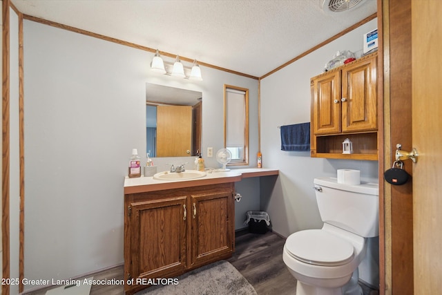 2744 Carlisle Hwy, Charlotte, MI 48813 - half bath with crown molding, wood finished floors, vanity, and a textured ceiling