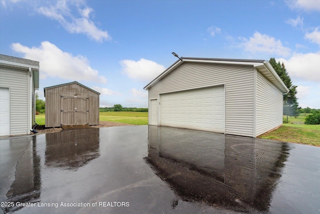 2744 Carlisle Hwy, Charlotte, MI 48813 - detached garage featuring a storage shed