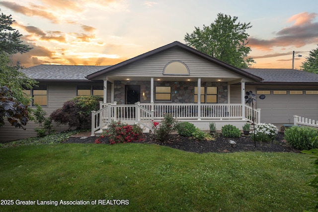 888 S Waverly Rd, Eaton Rapids, MI 48827 - ranch-style house featuring covered porch, a garage, a yard, and stone siding