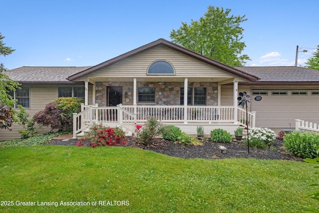 888 S Waverly Rd, Eaton Rapids, MI 48827 - ranch-style home with a porch, a garage, a front yard, and stone siding