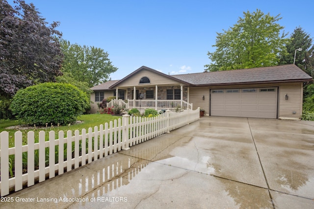 888 S Waverly Rd, Eaton Rapids, MI 48827 - single story home with covered porch, a garage, a fenced front yard, and concrete driveway
