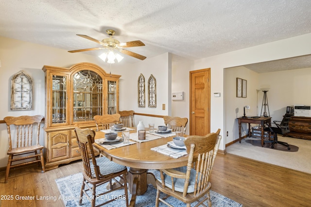 888 S Waverly Rd, Eaton Rapids, MI 48827 - dining area featuring a textured ceiling, light wood-style flooring, and a ceiling fan
