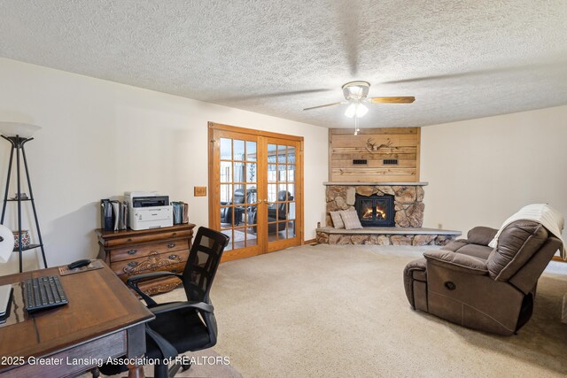 888 S Waverly Rd, Eaton Rapids, MI 48827 - carpeted office space with french doors, a ceiling fan, a stone fireplace, and a textured ceiling