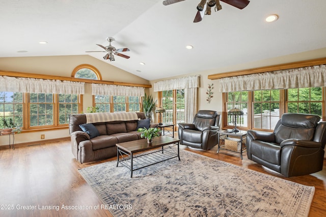 888 S Waverly Rd, Eaton Rapids, MI 48827 - living area with ceiling fan, vaulted ceiling, healthy amount of natural light, wood finished floors, and recessed lighting