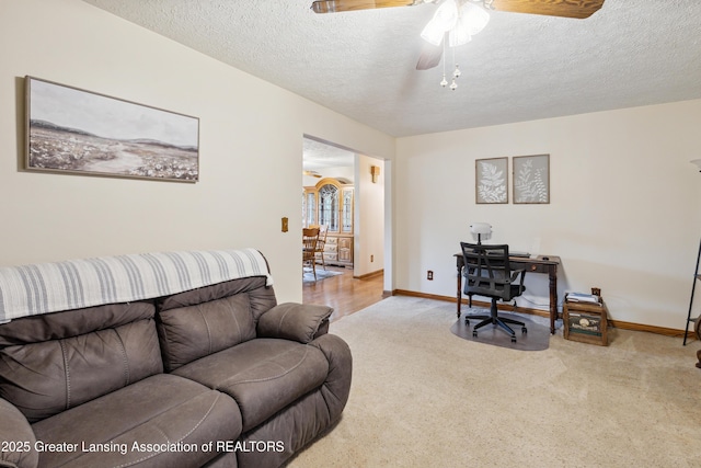 888 S Waverly Rd, Eaton Rapids, MI 48827 - carpeted living area featuring a textured ceiling, a ceiling fan, and a desk