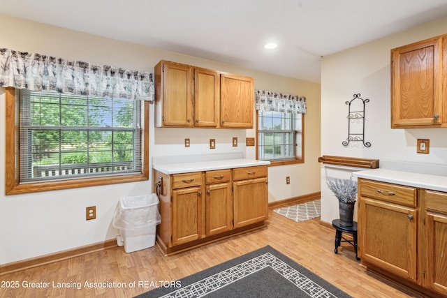 888 S Waverly Rd, Eaton Rapids, MI 48827 - kitchen with light countertops, light wood-style flooring, recessed lighting, and brown cabinets