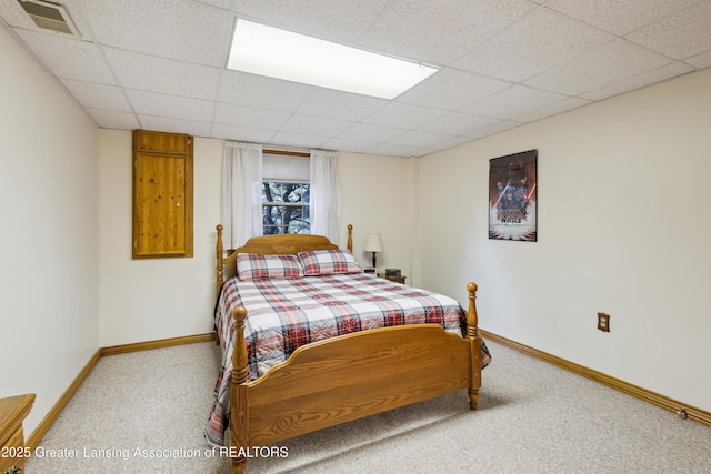 888 S Waverly Rd, Eaton Rapids, MI 48827 - carpeted bedroom with baseboards and a drop ceiling