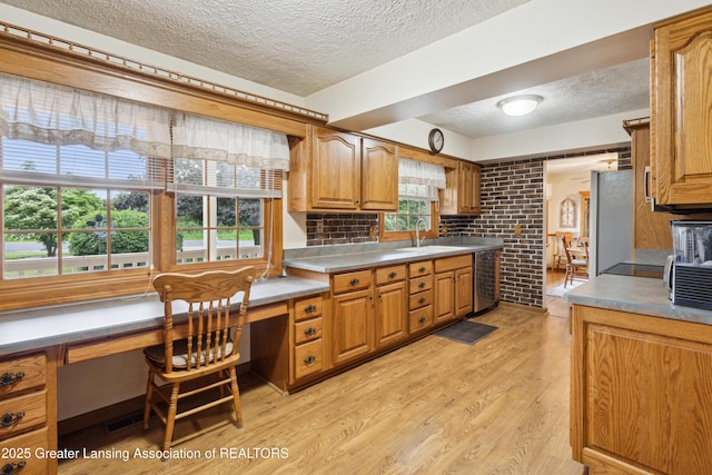 888 S Waverly Rd, Eaton Rapids, MI 48827 - kitchen with a textured ceiling, freestanding refrigerator, beverage cooler, light wood-style flooring, and brown cabinetry
