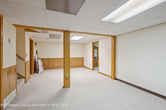888 S Waverly Rd, Eaton Rapids, MI 48827 - finished basement featuring wood walls, a drop ceiling, carpet floors, a wainscoted wall, and stairway