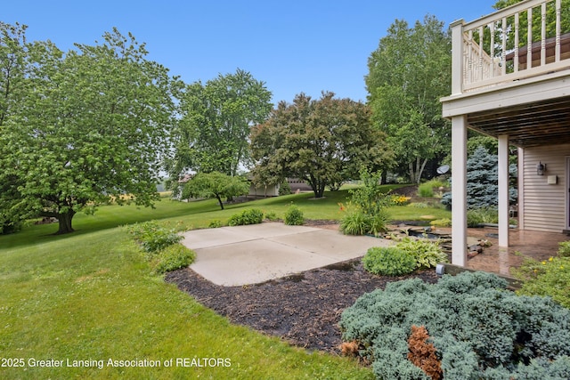 888 S Waverly Rd, Eaton Rapids, MI 48827 - view of grassy yard featuring a patio and a wooden deck