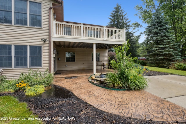 888 S Waverly Rd, Eaton Rapids, MI 48827 - rear view of property featuring a balcony and a patio area