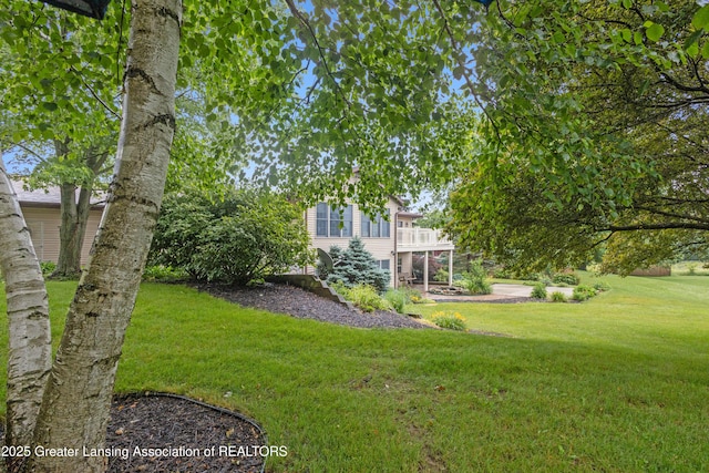 888 S Waverly Rd, Eaton Rapids, MI 48827 - view of grassy yard with a wooden deck