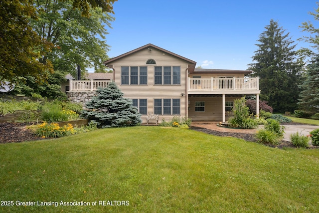 888 S Waverly Rd, Eaton Rapids, MI 48827 - back of house with a yard and a wooden deck
