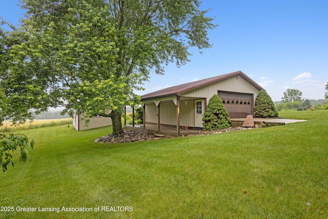 888 S Waverly Rd, Eaton Rapids, MI 48827 - view of green lawn with an outbuilding and a garage