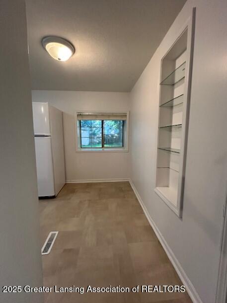 1318 Massachusetts Ave, Lansing, MI 48906 - spare room featuring baseboards and built in shelves