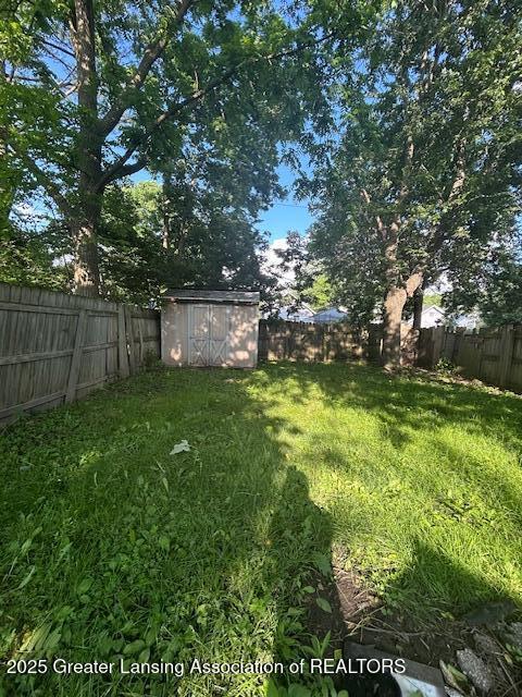 1318 Massachusetts Ave, Lansing, MI 48906 - fenced backyard featuring a storage unit