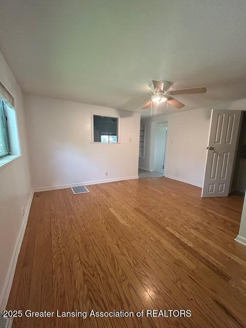 1318 Massachusetts Ave, Lansing, MI 48906 - spare room with wood finished floors and ceiling fan