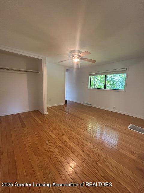 1318 Massachusetts Ave, Lansing, MI 48906 - unfurnished bedroom with hardwood / wood-style flooring, a closet, and ceiling fan