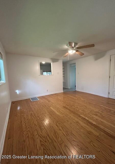1318 Massachusetts Ave, Lansing, MI 48906 - spare room featuring wood finished floors and ceiling fan