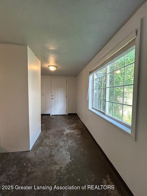 1318 Massachusetts Ave, Lansing, MI 48906 - unfurnished room with concrete floors