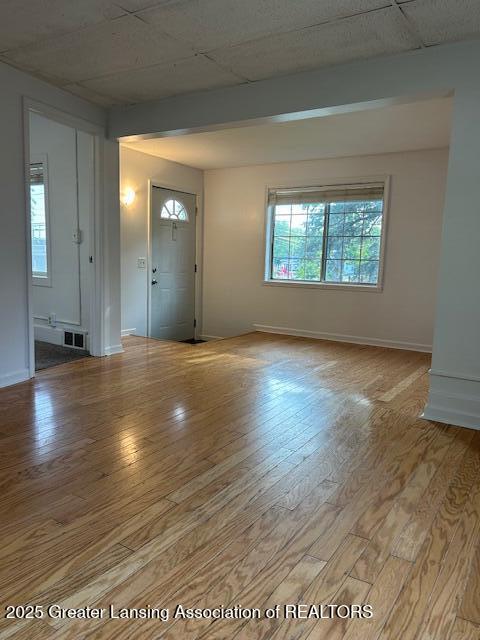 1318 Massachusetts Ave, Lansing, MI 48906 - unfurnished living room featuring light wood-style floors and plenty of natural light
