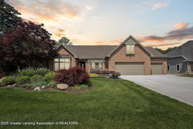 502 W Spring Meadows Ln, Dewitt, MI 48820 - view of front facade with brick siding, driveway, a lawn, an attached garage, and roof with shingles