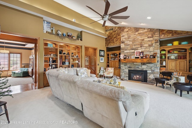 502 W Spring Meadows Ln, Dewitt, MI 48820 - living area with light carpet, ceiling fan, high vaulted ceiling, built in shelves, and a fireplace