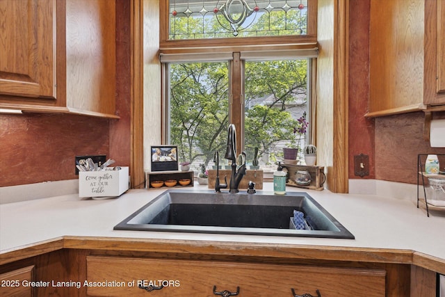 502 W Spring Meadows Ln, Dewitt, MI 48820 - kitchen with light countertops and brown cabinets