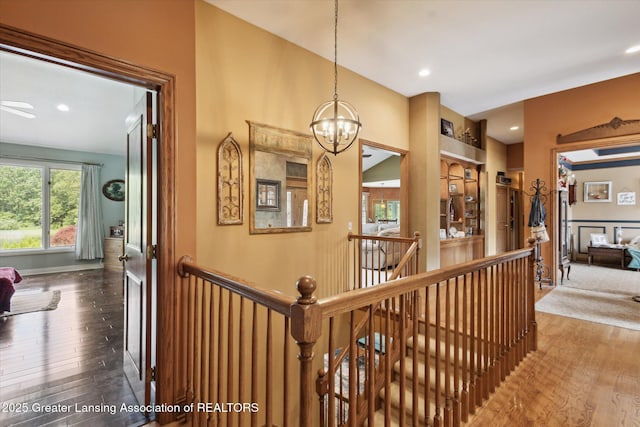 502 W Spring Meadows Ln, Dewitt, MI 48820 - hall featuring an upstairs landing, wood-type flooring, a chandelier, and recessed lighting