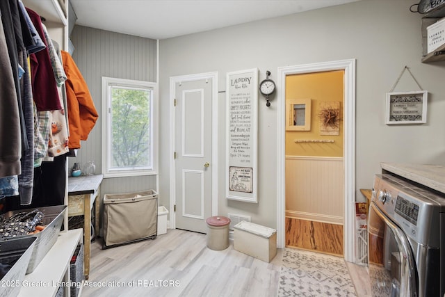 502 W Spring Meadows Ln, Dewitt, MI 48820 - laundry area with washer / clothes dryer, wood finished floors, and wainscoting