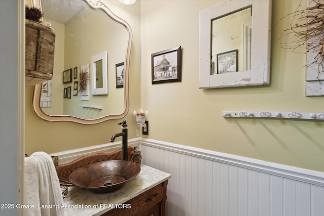 502 W Spring Meadows Ln, Dewitt, MI 48820 - bathroom featuring wainscoting and vanity