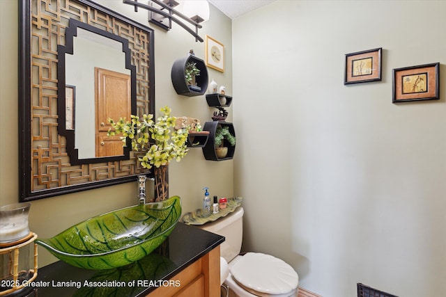 502 W Spring Meadows Ln, Dewitt, MI 48820 - half bathroom featuring toilet and vanity