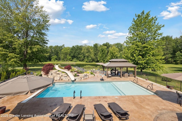 502 W Spring Meadows Ln, Dewitt, MI 48820 - view of swimming pool featuring a water slide, a patio area, a gazebo, and view of wooded area