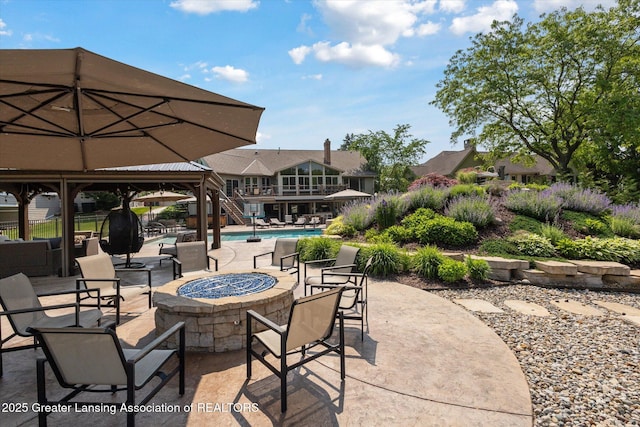 502 W Spring Meadows Ln, Dewitt, MI 48820 - view of patio featuring an outdoor fire pit, stairway, and an outdoor pool