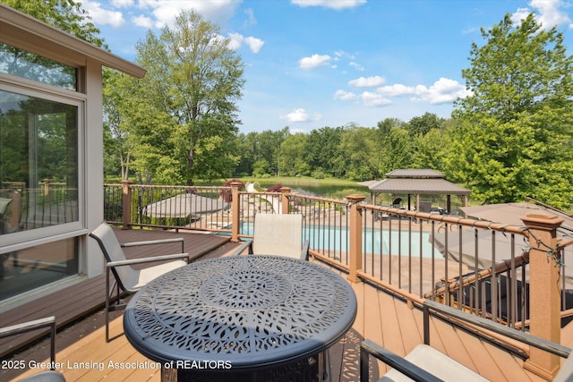 502 W Spring Meadows Ln, Dewitt, MI 48820 - deck featuring a gazebo and view of wooded area