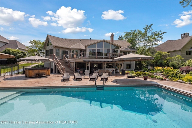 502 W Spring Meadows Ln, Dewitt, MI 48820 - swimming pool with a hot tub, a patio, stairs, and a wooden deck