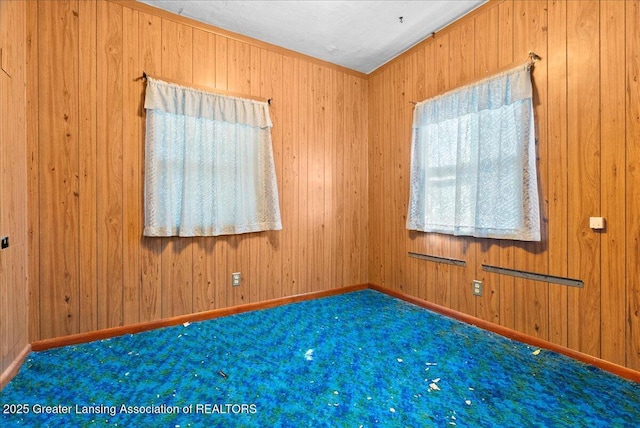 952 Leslie St, Lansing, MI 48912 - carpeted spare room with wood walls