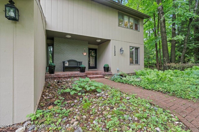 1122 Farwood Dr, East Lansing, MI 48823 - property entrance featuring brick siding and covered porch