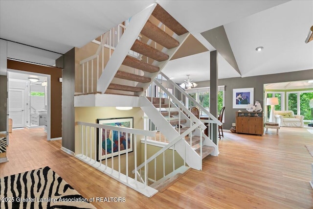 1122 Farwood Dr, East Lansing, MI 48823 - stairs with wood finished floors, healthy amount of natural light, and a chandelier