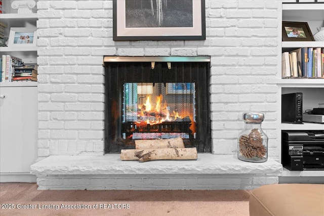 1122 Farwood Dr, East Lansing, MI 48823 - detailed view of a brick fireplace and wood finished floors